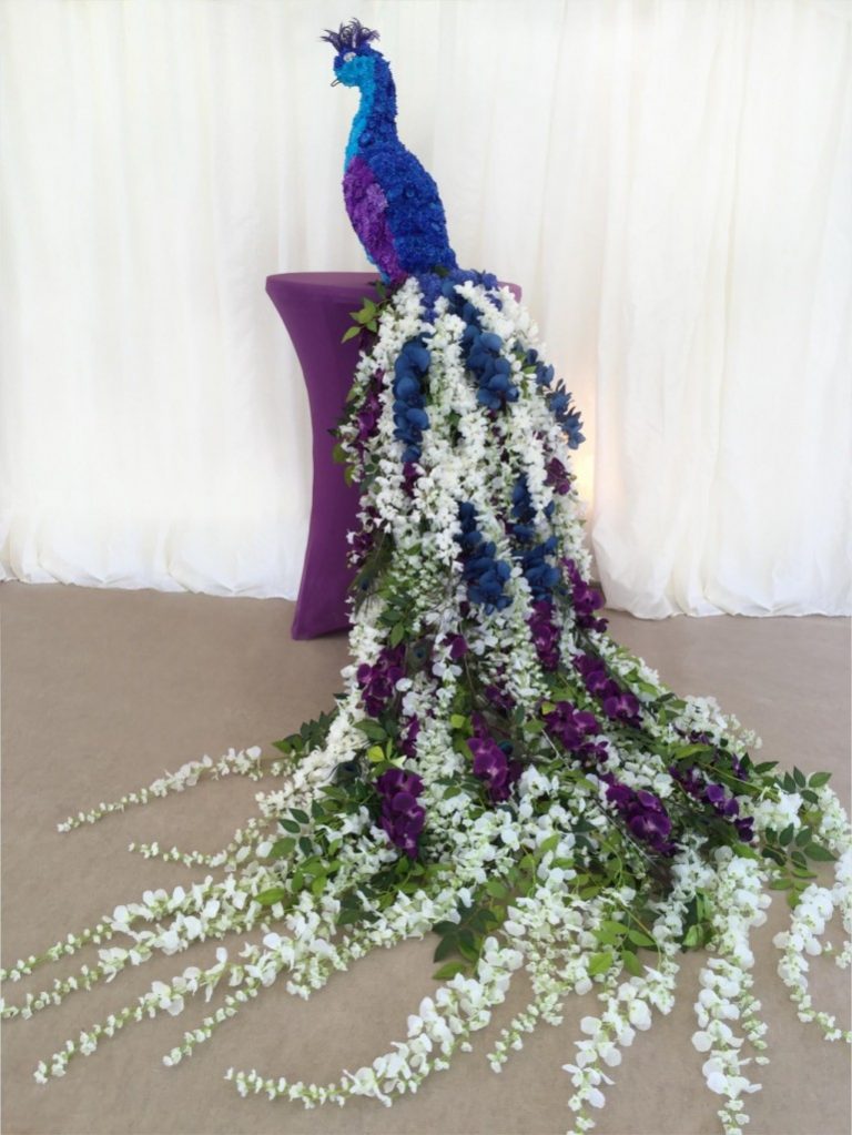 Topiary peacock made with living and artificial flowers.