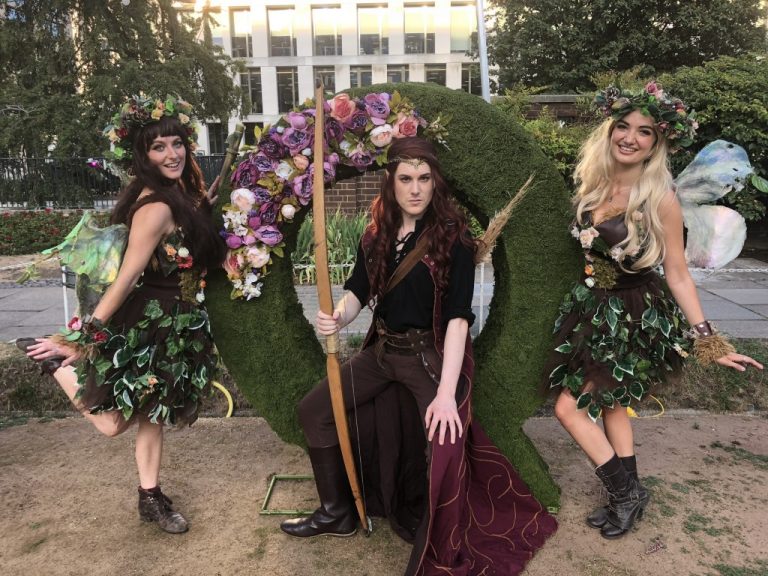 Quantcast logo in moss topiary with 3 cosplay models