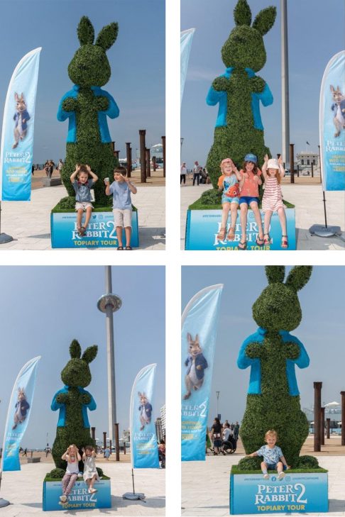 Children posing with the Peter Rabbit sculpture